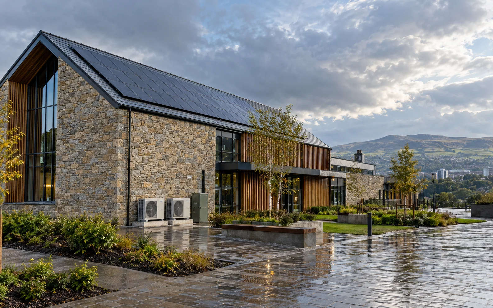 Scottish building with solar panels and renewable heating equipment