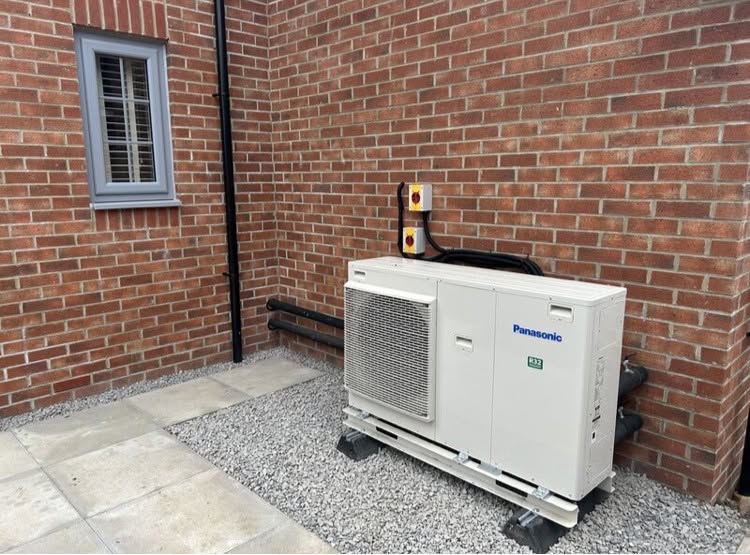 FLO air source heat pump installed beside a brick Scottish property